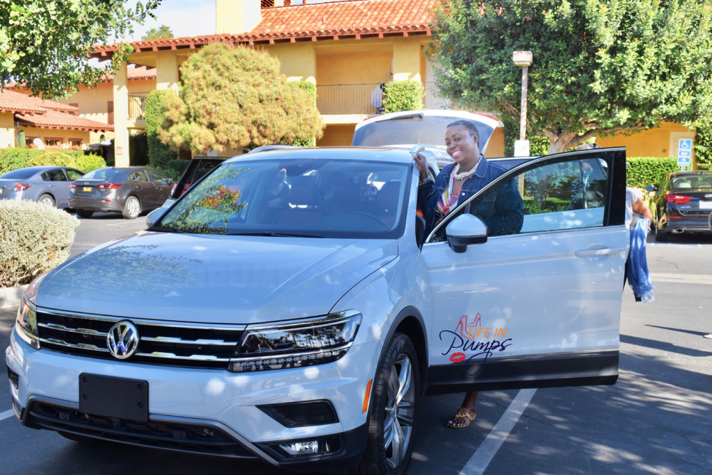Brown female driving the VW Tiguan . #Drive2Learn