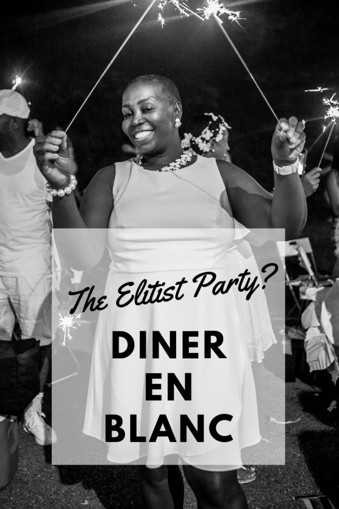 Brown girl displays sparklers at Diner en blanc