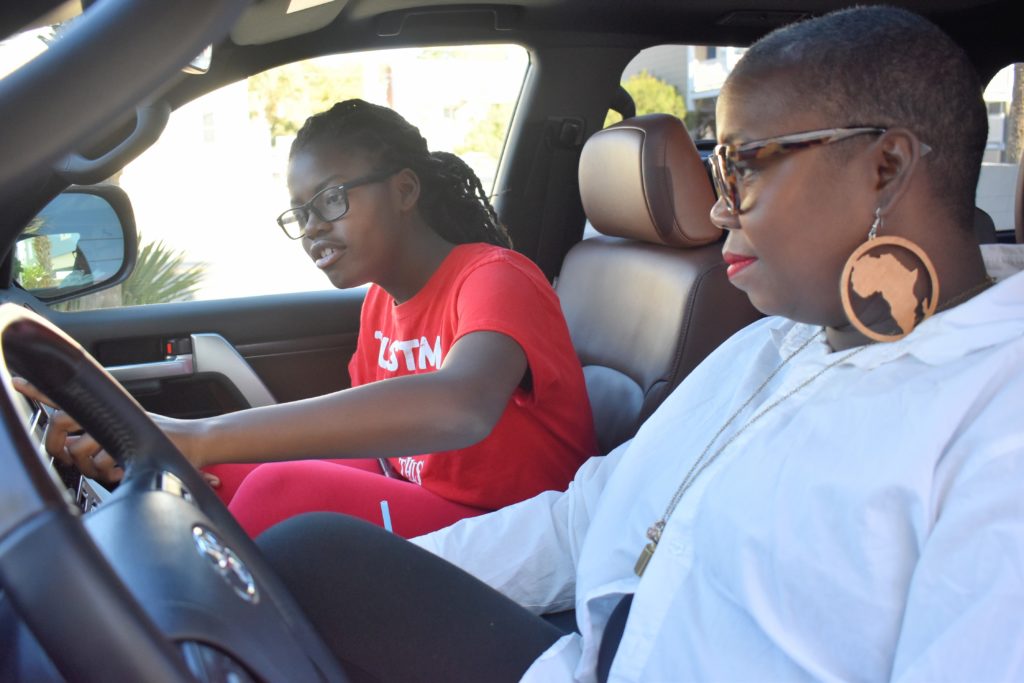 brown skin girls in the Toyota Landcruiser- what drives her