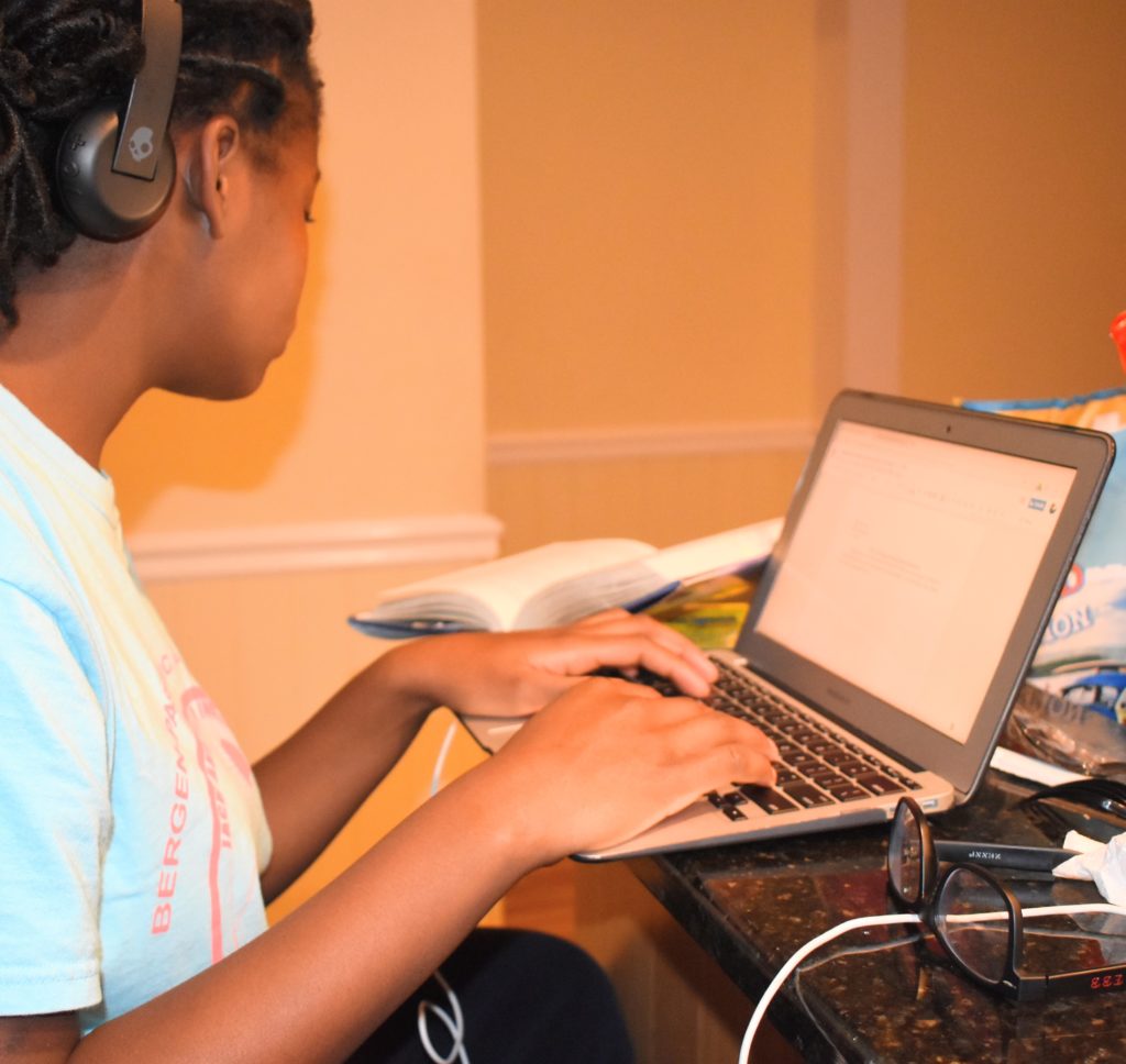 busy and motivated quarantine kid on computer homeschool
