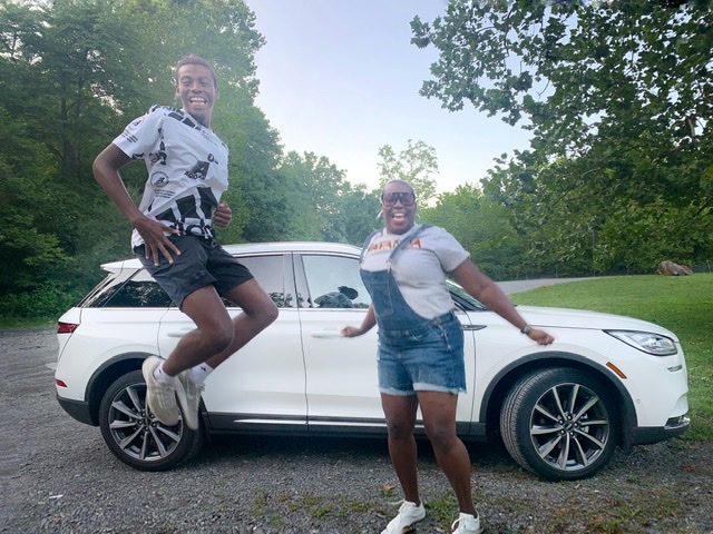 Black Mom/Son Jumping Dancing with Lincoln Corsair Sanctuary in Philly