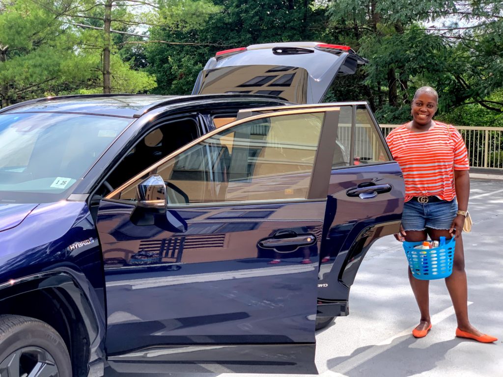 Brown Girl near Toyota RAV4 with Emergency Quarantine Kit wearing Rothys and a Gucci Belt