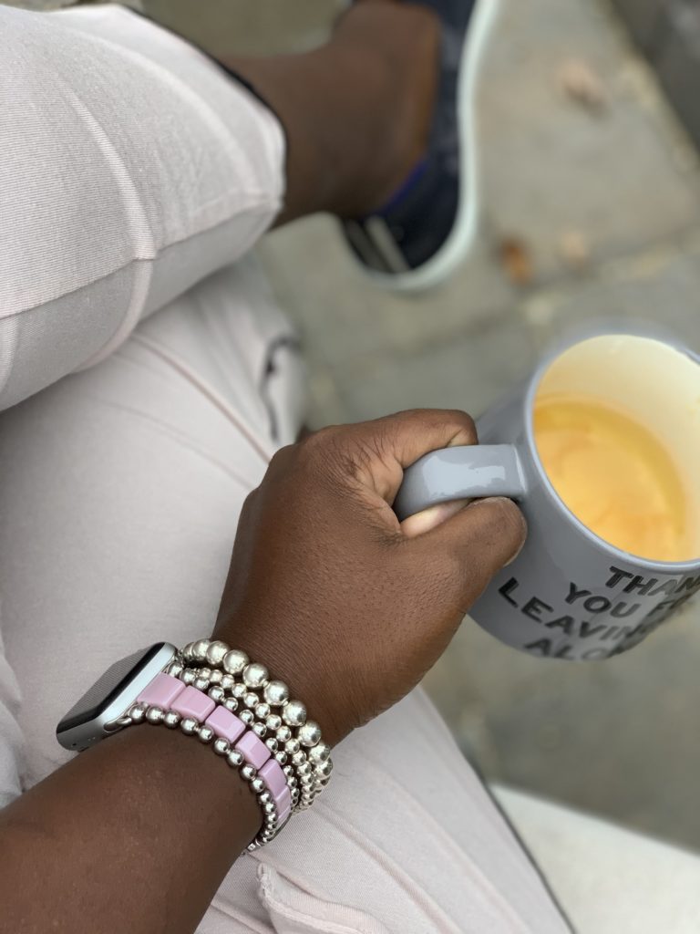 Brow Girl enjoying cup of tea with Lagos jewelry self care in pink